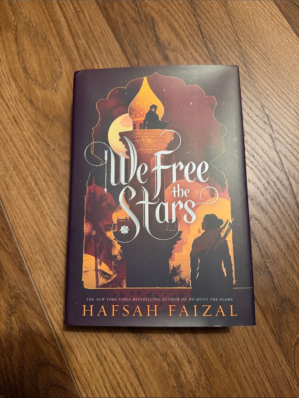 We Free the Stars by Hafsah Faizal - Maroon & Orange Hardcover